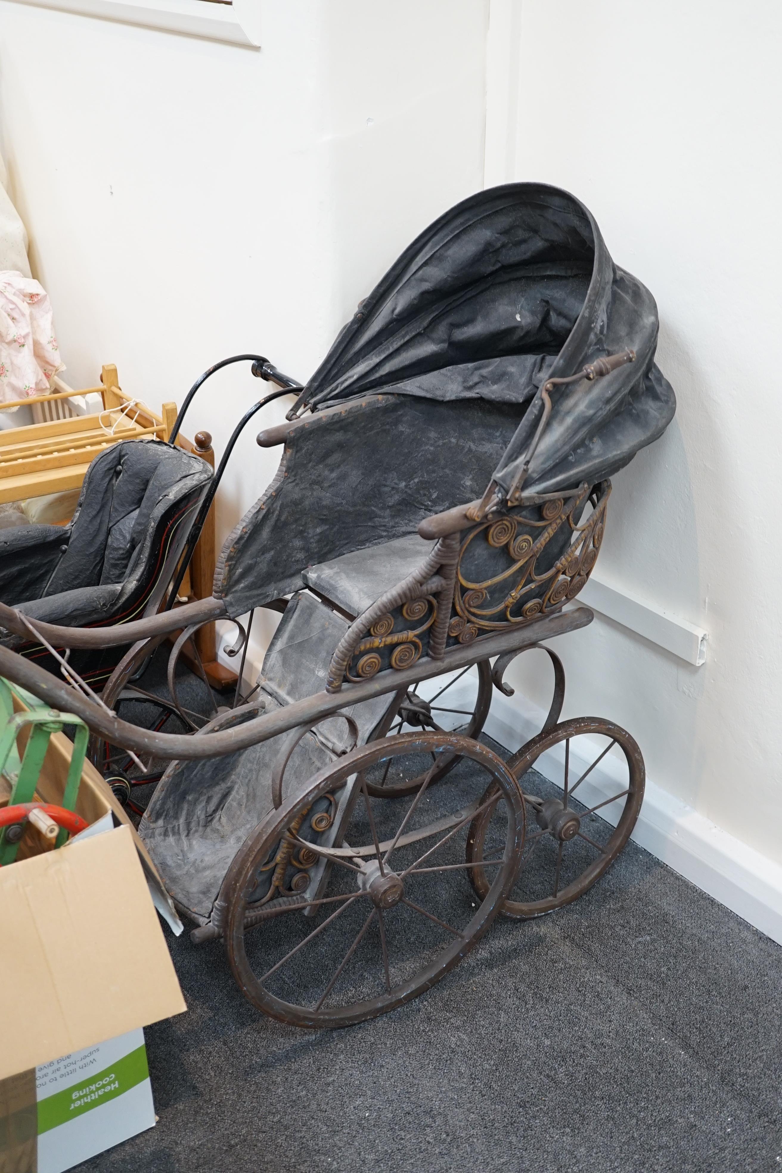 A collection of nine doll’s cribs of wood or wrought iron construction, together with two nineteenth century style doll’s ’bath chairs’, a toy mangle, Disney themed Snow White carpet sweeper and a boxed child’s sewing ma
